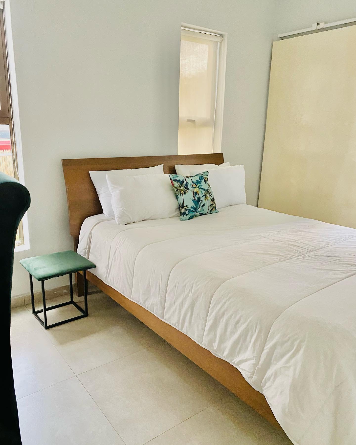 A made-up king room at White House Residences